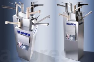 Floor display/promotional display for Blanco with a base plate made of chipboard, surrounded by a silver-coloured embossed polystyrene casing with an imprinted logo. The brochure holder made of acrylic glass offers space for customer information.